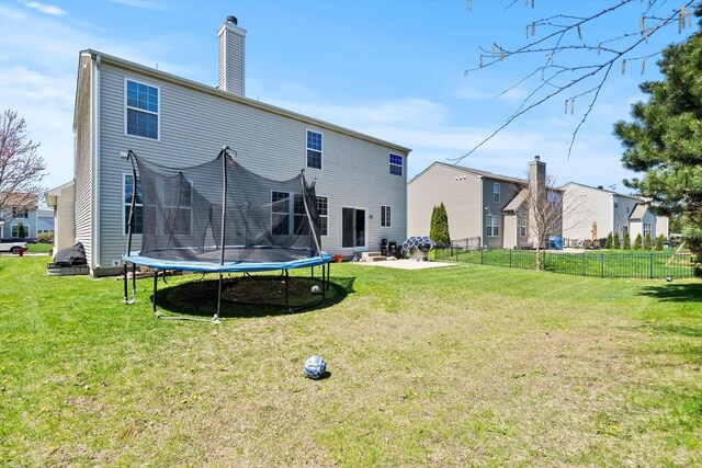 3210 Drury Ln, Carpentersville, IL 60110 - back of house with a patio area, a trampoline, and a chimney