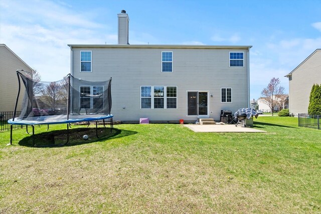 3210 Drury Ln, Carpentersville, IL 60110 - back of house with a trampoline, a patio, a chimney, and entry steps