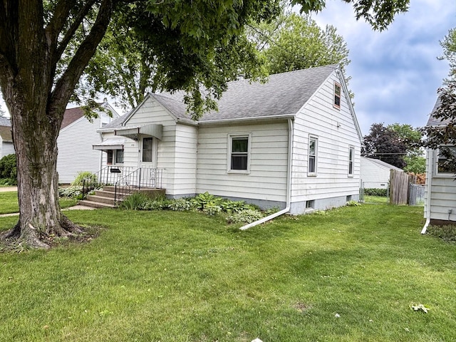 1711 17th Ave, Sterling, IL 61081 - view of front of house featuring roof with shingles and a front lawn