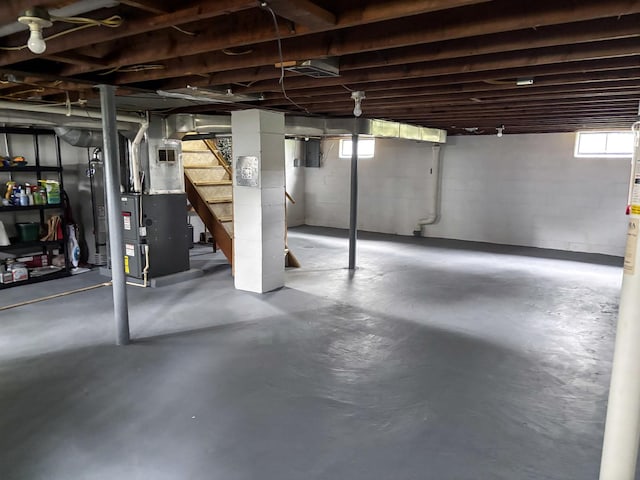 1711 17th Ave, Sterling, IL 61081 - below grade area featuring healthy amount of natural light, heating unit, and stairs