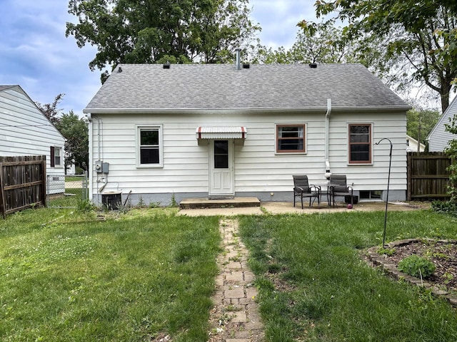 1711 17th Ave, Sterling, IL 61081 - rear view of property featuring roof with shingles and a patio area