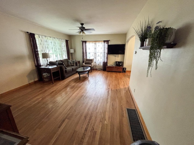 1711 17th Ave, Sterling, IL 61081 - living area with a ceiling fan, wood finished floors, arched walkways, and baseboards