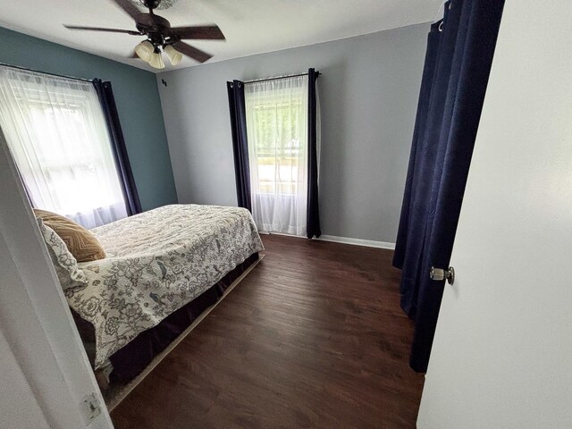1711 17th Ave, Sterling, IL 61081 - bedroom with dark wood-style flooring, baseboards, and a ceiling fan