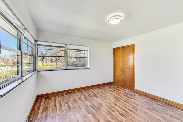 141 W 13th St, Chicago Heights, IL 60411 - empty room featuring light wood-type flooring, baseboards, and a baseboard radiator