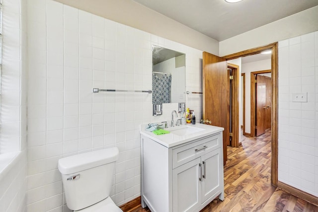 141 W 13th St, Chicago Heights, IL 60411 - full bathroom featuring tile walls, vanity, toilet, and wood finished floors