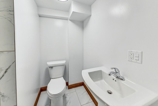 141 W 13th St, Chicago Heights, IL 60411 - half bathroom featuring toilet, marble look tiles, baseboards, and a sink