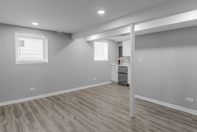 10507 S Indiana Ave, Chicago, IL 60628 - below grade area with stainless steel refrigerator, recessed lighting, light wood-style floors, baseboards, and bar area