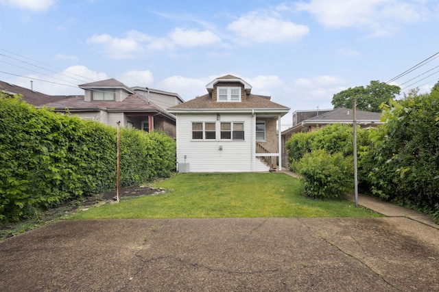3006 N Sayre Ave, Chicago, IL 60634 - back of house with a lawn, cooling unit, and roof with shingles