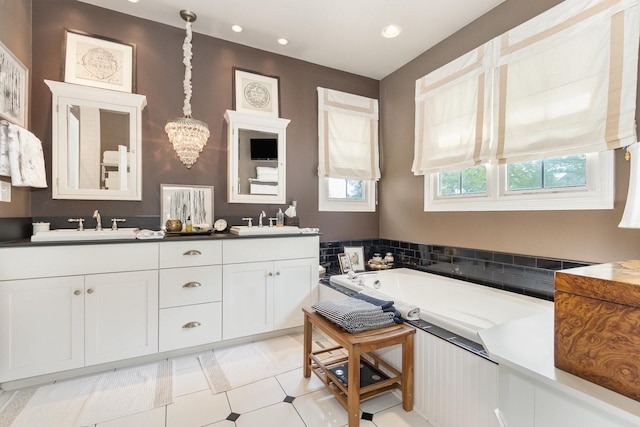 140 N Oak St, Elmhurst, IL 60126 - bathroom with double vanity, a garden tub, a chandelier, and recessed lighting