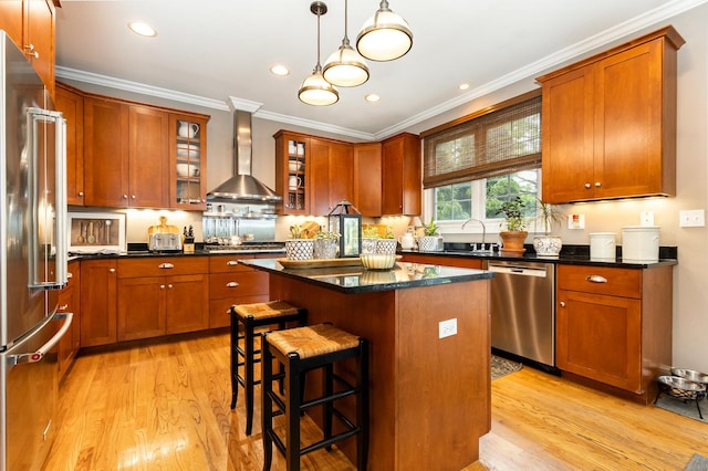 140 N Oak St, Elmhurst, IL 60126 - kitchen with wall chimney exhaust hood, appliances with stainless steel finishes, ornamental molding, light wood finished floors, and a kitchen island