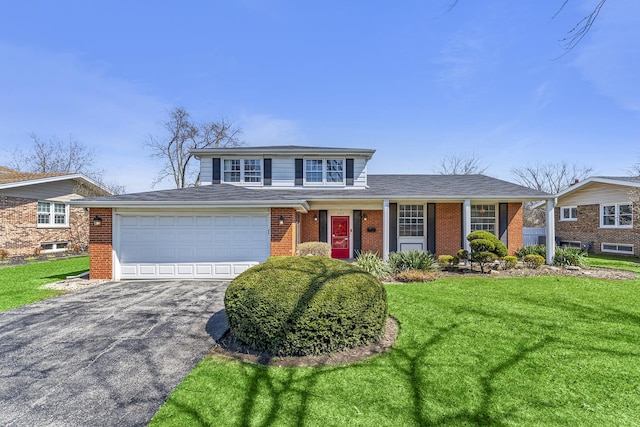 2213 Strawberry Ln, Glenview, IL 60026 - traditional home featuring asphalt driveway, brick siding, a front lawn, and an attached garage