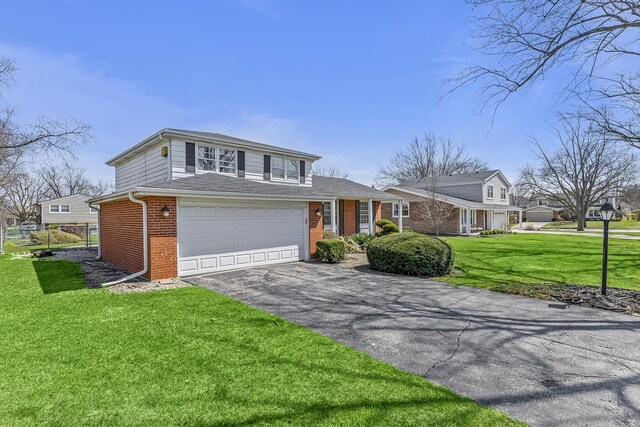 2213 Strawberry Ln, Glenview, IL 60026 - view of front of property featuring brick siding, driveway, a front yard, and an attached garage