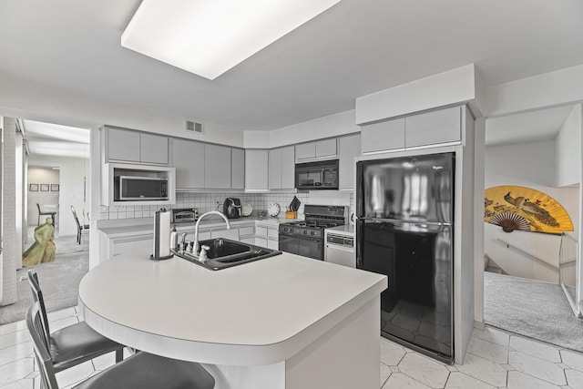 2213 Strawberry Ln, Glenview, IL 60026 - kitchen with black appliances, gray cabinetry, a sink, and light countertops