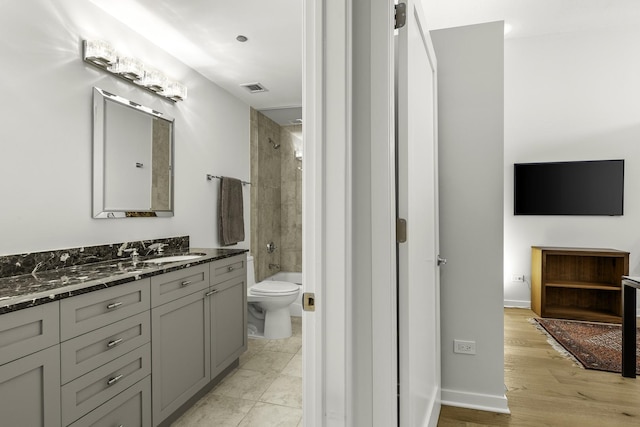 333 N Canal St Unit 2804, Chicago, IL 60606 - full bath featuring vanity, toilet, shower / tub combination, baseboards, and wood finished floors