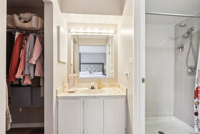 68 Pier Dr Unit 102, Westmont, IL 60559 - full bathroom featuring connected bathroom, a tile shower, vanity, and a walk in closet