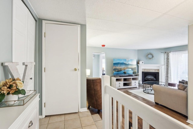 68 Pier Dr Unit 102, Westmont, IL 60559 - living area with a fireplace with raised hearth and light tile patterned floors