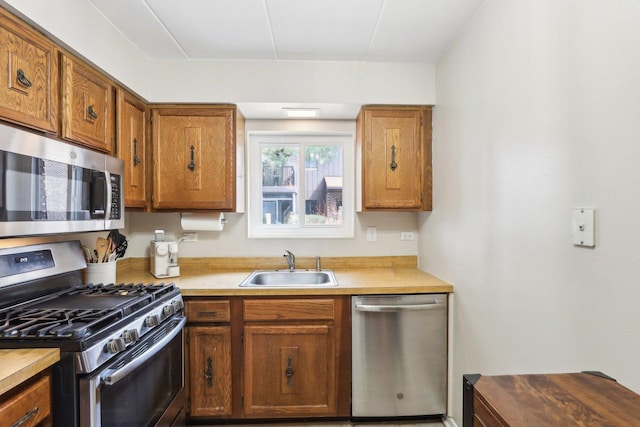 68 Pier Dr Unit 102, Westmont, IL 60559 - kitchen featuring stainless steel appliances, a sink, light countertops, and brown cabinets