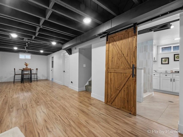 490 S Mchenry Ave, Crystal Lake, IL 60014 - below grade area with a barn door, light wood-style flooring, and stairs