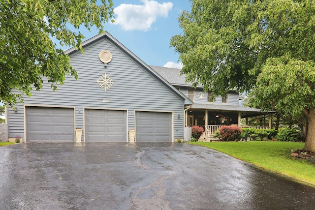 304 Fairhaven Dr, Winthrop Harbor, IL 60096 - view of front of house with driveway, a garage, a front lawn, covered porch, and a shingled roof