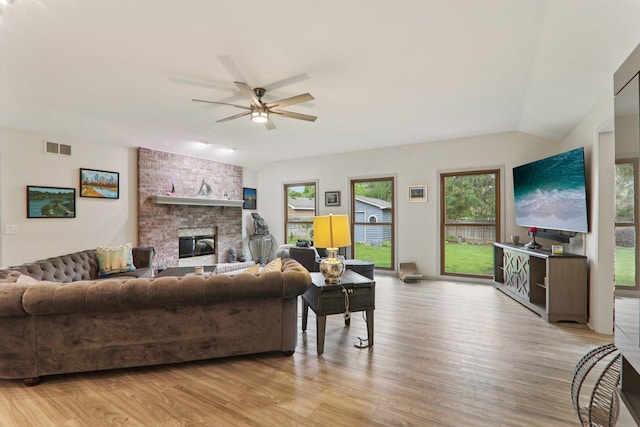 304 Fairhaven Dr, Winthrop Harbor, IL 60096 - living area featuring light wood-type flooring, a ceiling fan, a fireplace, and vaulted ceiling