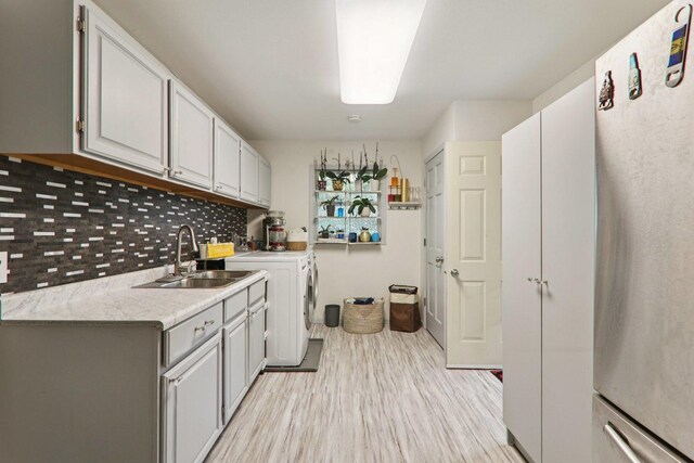 304 Fairhaven Dr, Winthrop Harbor, IL 60096 - laundry room featuring washer and dryer, light wood-type flooring, and cabinet space
