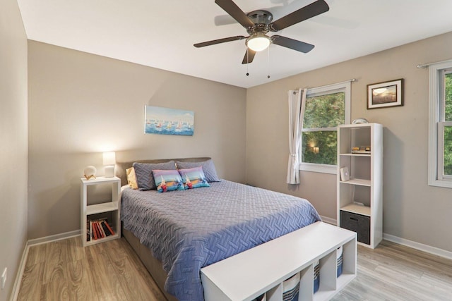 304 Fairhaven Dr, Winthrop Harbor, IL 60096 - bedroom featuring light wood-style floors, multiple windows, and a ceiling fan