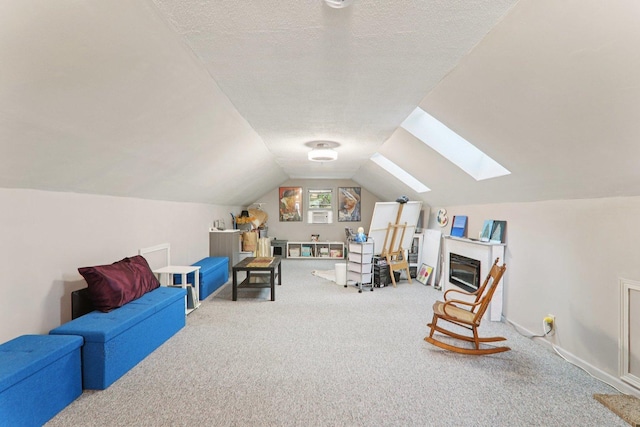 304 Fairhaven Dr, Winthrop Harbor, IL 60096 - sitting room with a skylight, carpet flooring, vaulted ceiling, a textured ceiling, and a glass covered fireplace