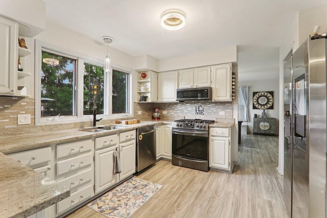 304 Fairhaven Dr, Winthrop Harbor, IL 60096 - kitchen featuring appliances with stainless steel finishes, open shelves, light stone countertops, and decorative backsplash