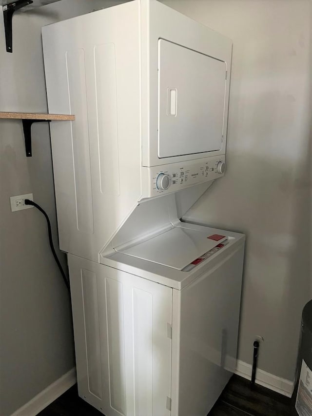 1279 Prairie Ave Unit C, Glendale Heights, IL 60139 - laundry room with stacked washer and clothes dryer, baseboards, and dark wood-style floors