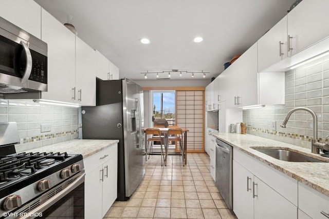 4747 Howard St Unit 205, Skokie, IL 60076 - kitchen featuring appliances with stainless steel finishes, tasteful backsplash, white cabinetry, recessed lighting, and light stone countertops