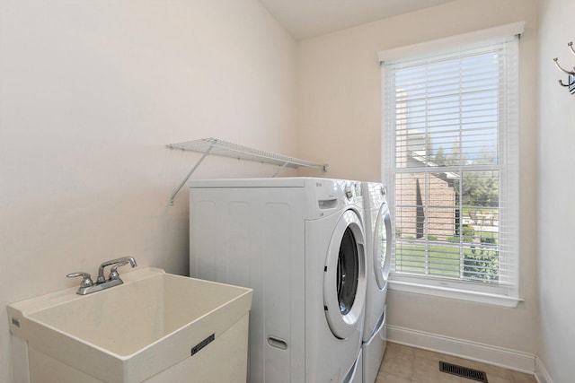 4 Tournament Dr S, Hawthorn Woods, IL 60047 - laundry area with washer and clothes dryer, healthy amount of natural light, baseboards, and light tile patterned floors