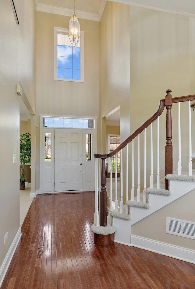 4 Tournament Dr S, Hawthorn Woods, IL 60047 - foyer with wood-type flooring, a chandelier, baseboards, ornamental molding, and stairway