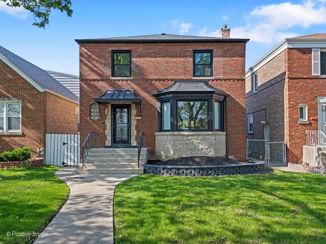 1910 W 83rd St, Chicago, IL 60620 - traditional home with a gate, a chimney, and brick siding