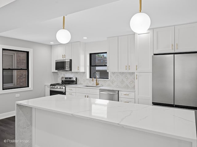 1910 W 83rd St, Chicago, IL 60620 - kitchen with appliances with stainless steel finishes, a sink, backsplash, white cabinets, and recessed lighting
