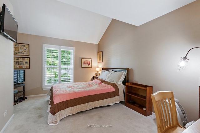 carpeted bedroom featuring lofted ceiling and baseboards