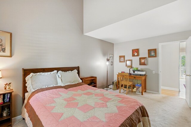 bedroom with carpet flooring and an office area