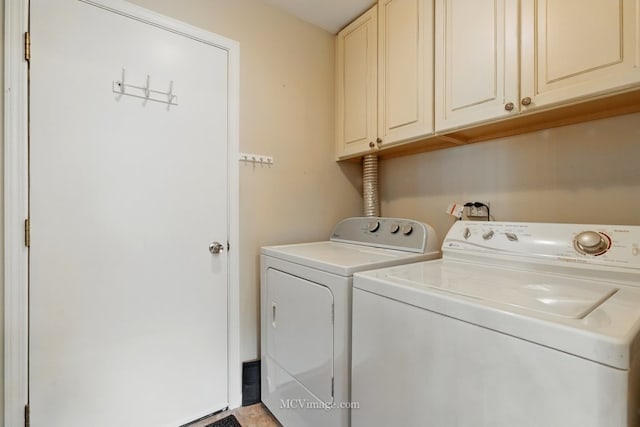 washroom with washer and dryer and cabinet space