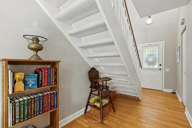 foyer entrance with wood finished floors and stairs