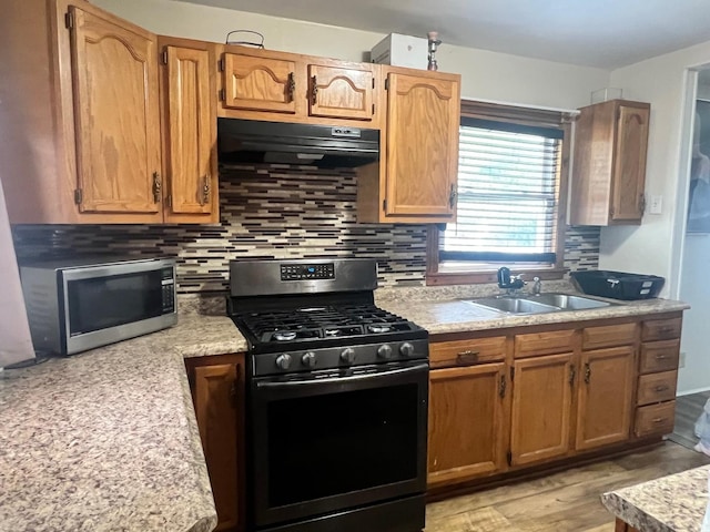 14701 E Riverside Dr, South Holland, IL 60473 - kitchen with range with gas stovetop, stainless steel microwave, a sink, range hood, and light countertops