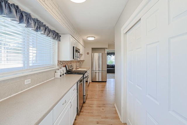 6124 Chase Ave, Downers Grove, IL 60516 - kitchen featuring stainless steel appliances, backsplash, light wood finished floors, white cabinets, and light countertops