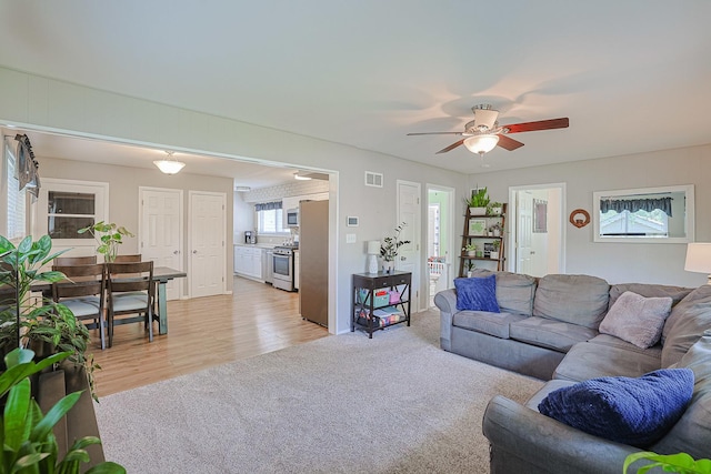 6124 Chase Ave, Downers Grove, IL 60516 - living room featuring ceiling fan, light carpet, and light wood-type flooring