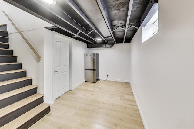 614 Beach Ave, La Grange Park, IL 60526 - finished basement with light wood-style flooring, freestanding refrigerator, and stairs