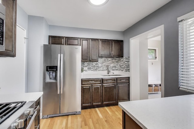 614 Beach Ave, La Grange Park, IL 60526 - kitchen featuring stainless steel fridge, light countertops, dark brown cabinets, and light wood-type flooring