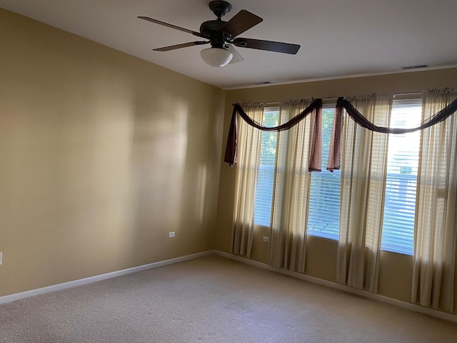3148 Ollerton Ave Unit 3148, Aurora, IL 60502 - empty room featuring ceiling fan, light carpet, baseboards, and healthy amount of natural light