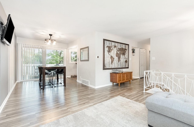 352 Falcon Ridge Way, Bolingbrook, IL 60440 - living room featuring light wood-style flooring, baseboards, and a chandelier