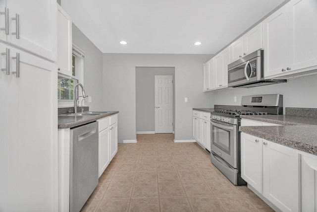 308 Tamarack Ave, Naperville, IL 60540 - kitchen featuring appliances with stainless steel finishes, a sink, white cabinets, recessed lighting, and baseboards