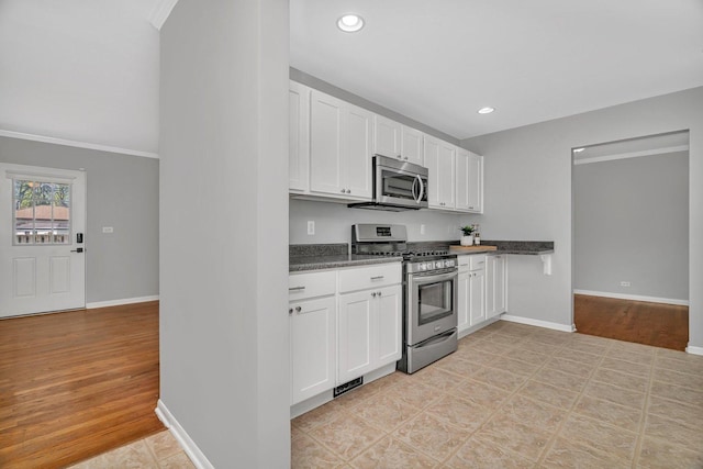 308 Tamarack Ave, Naperville, IL 60540 - kitchen with appliances with stainless steel finishes, white cabinets, dark countertops, baseboards, and recessed lighting