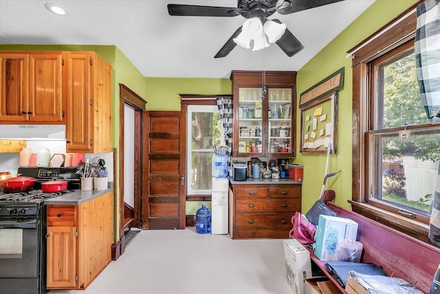 138 N Elm St, Paxton, IL 60957 - kitchen with black gas stove, under cabinet range hood, a ceiling fan, plenty of natural light, and recessed lighting
