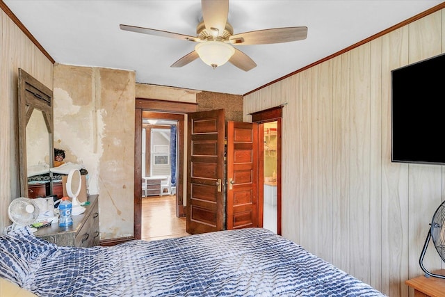 138 N Elm St, Paxton, IL 60957 - bedroom featuring crown molding, wooden walls, wood finished floors, and a ceiling fan