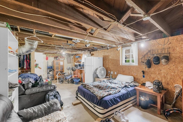 138 N Elm St, Paxton, IL 60957 - bedroom with unfinished concrete flooring and freestanding refrigerator